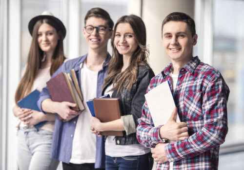 Group of happy young students in a university. Group of happy young students in a university.